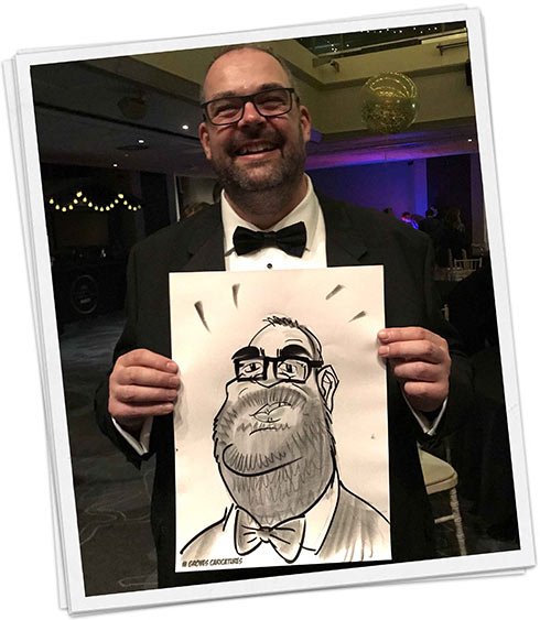 Brighton man holds his caricature Man holding his caricature at a corporate night out