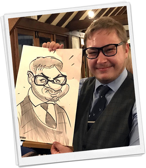 a man showing around his cartoon A man holding his caricature at a charity night