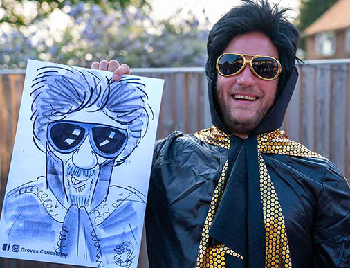 fancy dress garden party man poses for a caricature dressed as elvis with a wig