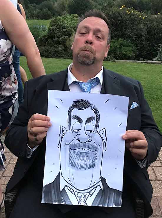 Ashford man shows his papered cartoon man shows off his caricature in ashford, kent