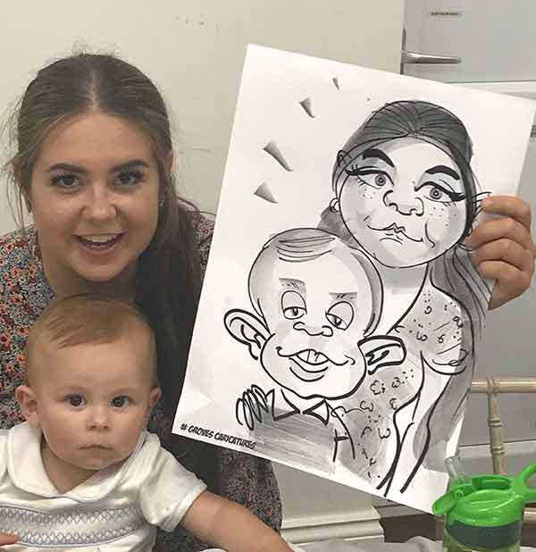 sweet baby and sister pose with their caricature in Dorset cute baby and sister pose with their caricature