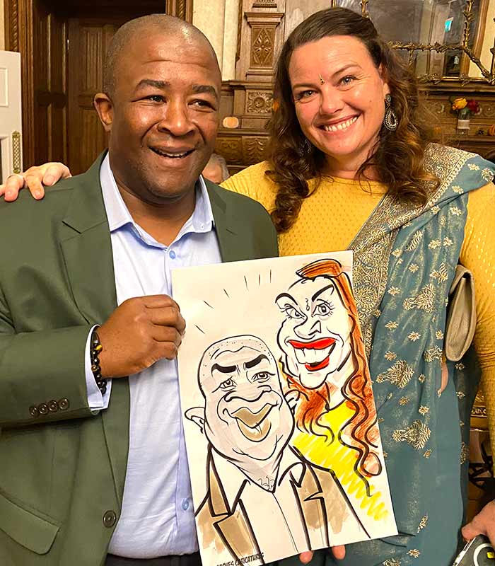 Wedding guests with drawing at Froyle Park Wedding guests with caricature at Froyle Park