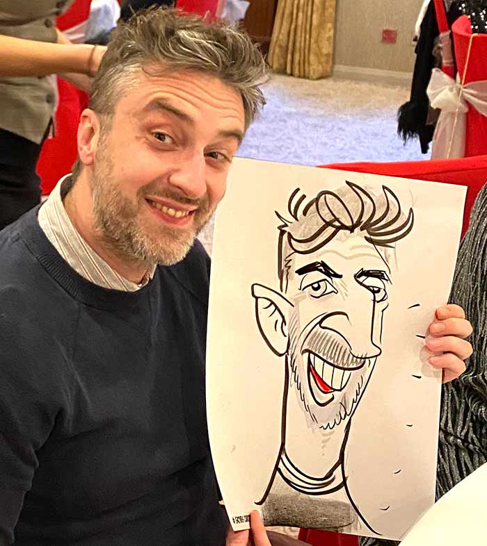 Dubious looking man with his cartoon drawing Dubious looking man with his caricature