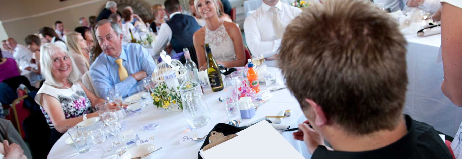 Caricaturist drawing around the tables in East Grinstead